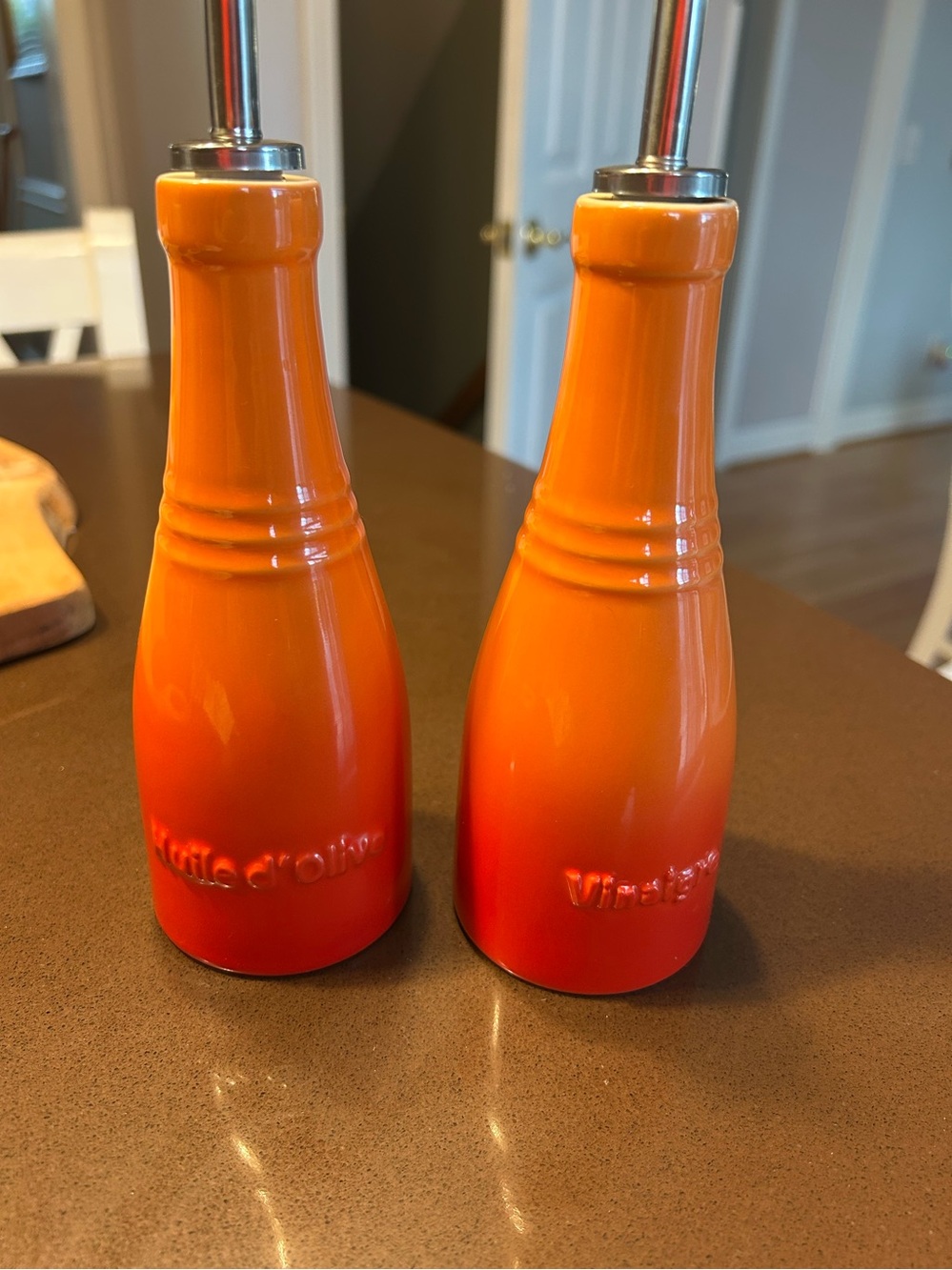 Matching Le Crueset oil and vinegar set in classic orange